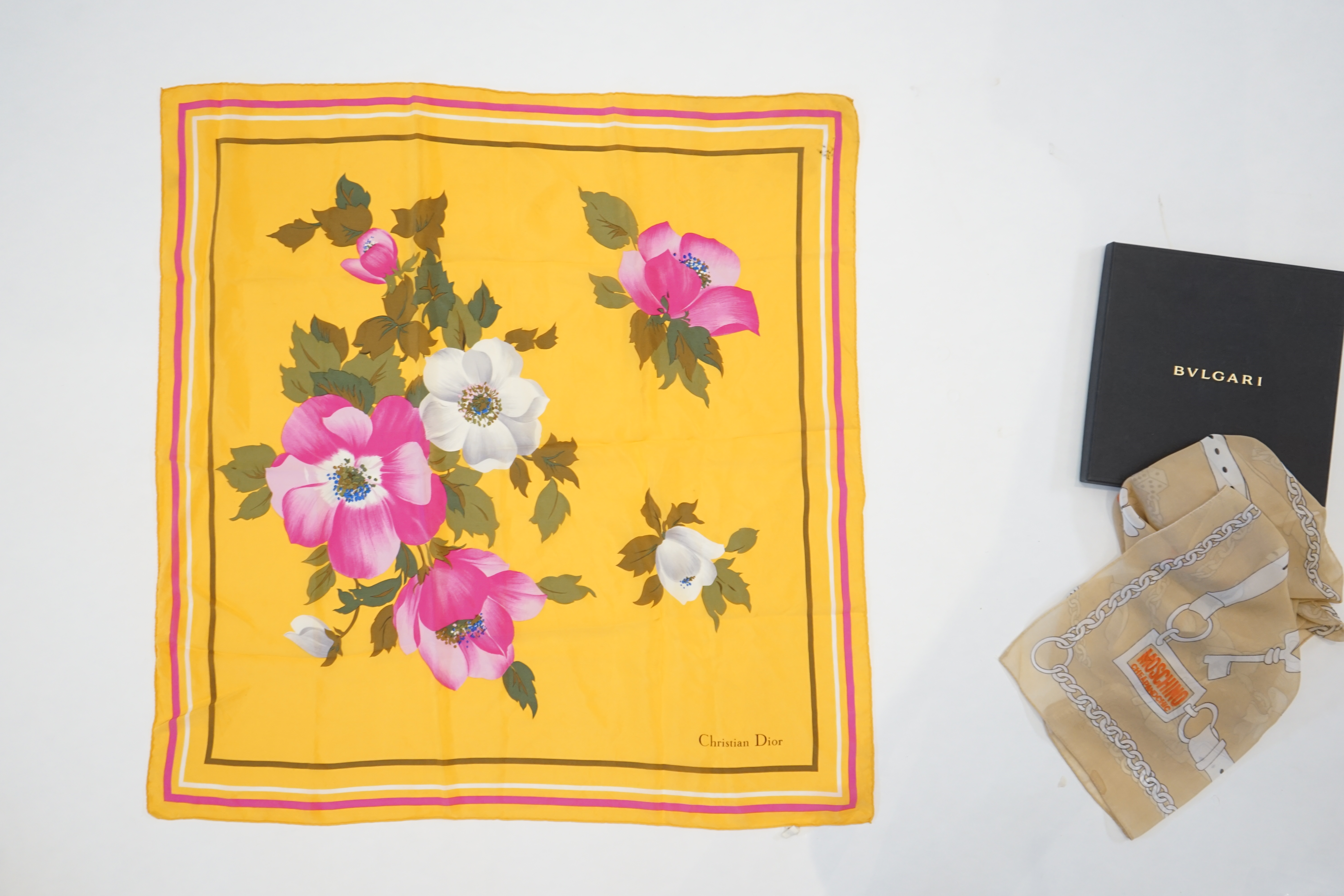 A Bvlgari by Davide Pizzigoni silk scarf, a yellow floral Christian Dior silk scarf and a Moschino Cheap and Chic chiffon scarf